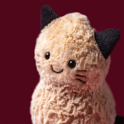 Detailansicht vom Lachgesicht mit schwarzen Katzenohren und den aufgemalten schwarzen Katzenhaaren des Jellycat Amuseables Peanut Cat