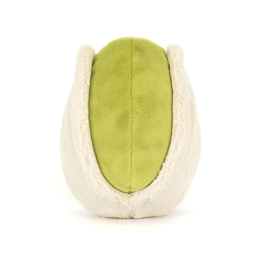 Rückansicht Jellycat Amuseables Pistachio – sitzende grüne Plüsch-Pistazie mit lachendem Gesicht und schwarzen Knopfaugen, die aus einer hellbeigen Hülle schaut und hellbraune Füßchen hat.