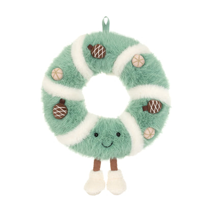 Jellycat Amuseables Pinecone Wreath – flauschiger Weihnachtskranz in Mintgrün und Cremeweiß mit kleinen Tannenzapfen, lächelndem Gesicht und weißen Füßchen, von vorne.