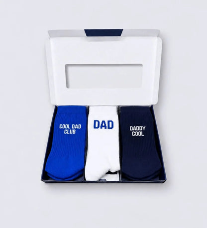Geöffnete DAD Geschenkbox von No Bad Days Club mit drei Paar Herrensocken in Blau, Weiß und Dunkelblau.