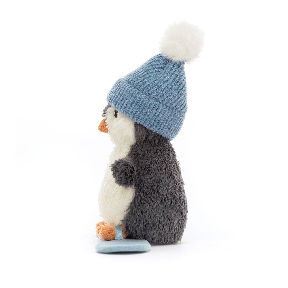 Seitenansicht Peanut Penguin Snowboarding von Jellycat.