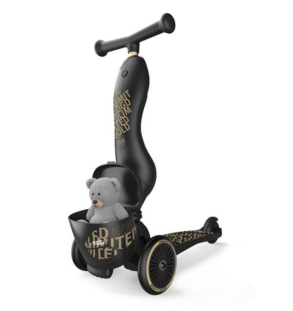 Scoot and Ride Highwaykick 1 Lifestyle Black Gold Kinderroller mit Sitz und Aufbewahrungsbox vorne in der ein grauer Teddy sitzt.