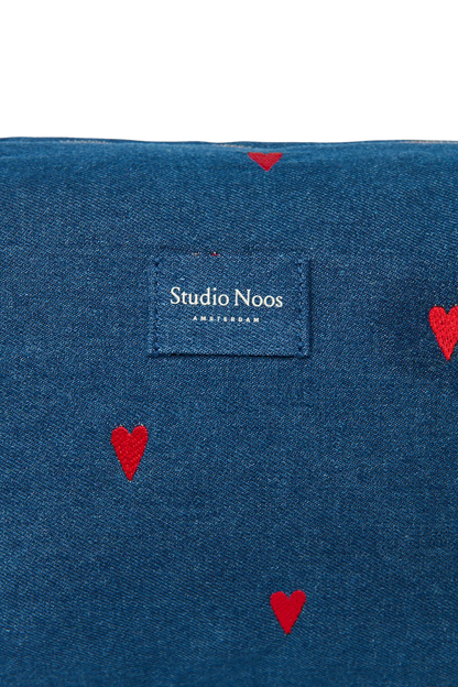 Detailansicht des Studio Noos Logos auf der dunkelblauen Kosmetiktasche Bag mit gestickten roten Herzen