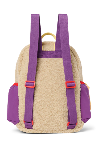 Rückansicht: Studio Noos Patchwork Midi-Rucksack l Bright Pink in bunten Farben mit beigem Teddy-Stoff an den Seiten und an der Rückseite, pinken Patchwork-Details und lila-rot-beigen Akzenten
