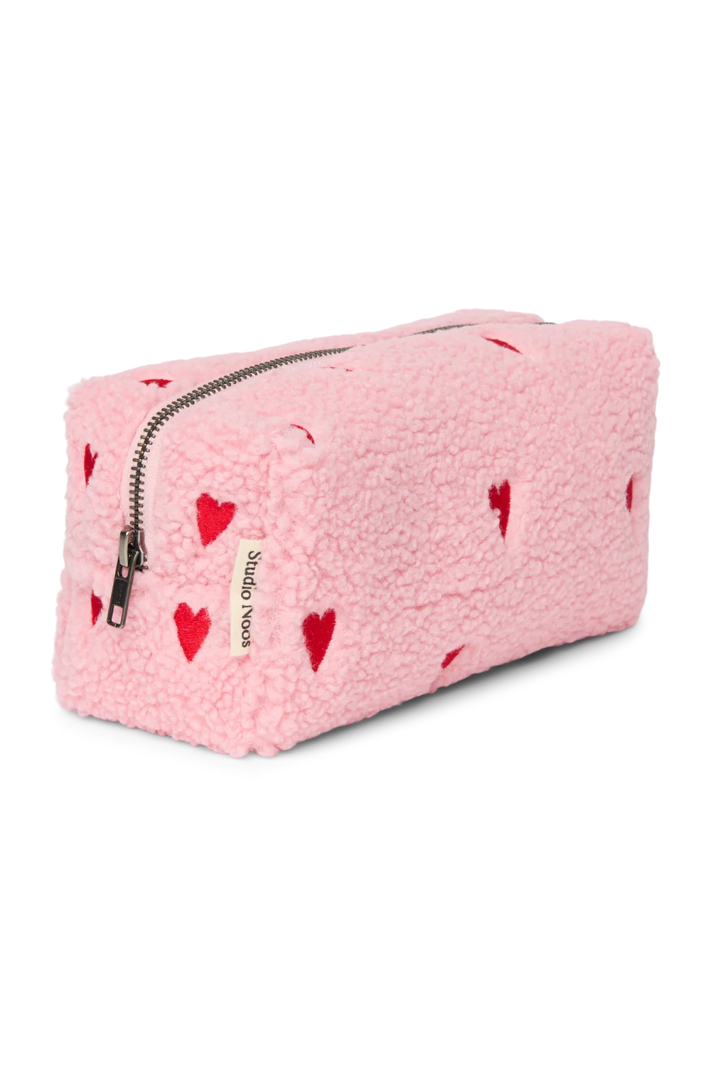 Seitenansicht der Studio Noos Pouch aus pinkem Teddystoff mit gestickten roten Herzen, Reißverschluss und Studio Noos Label