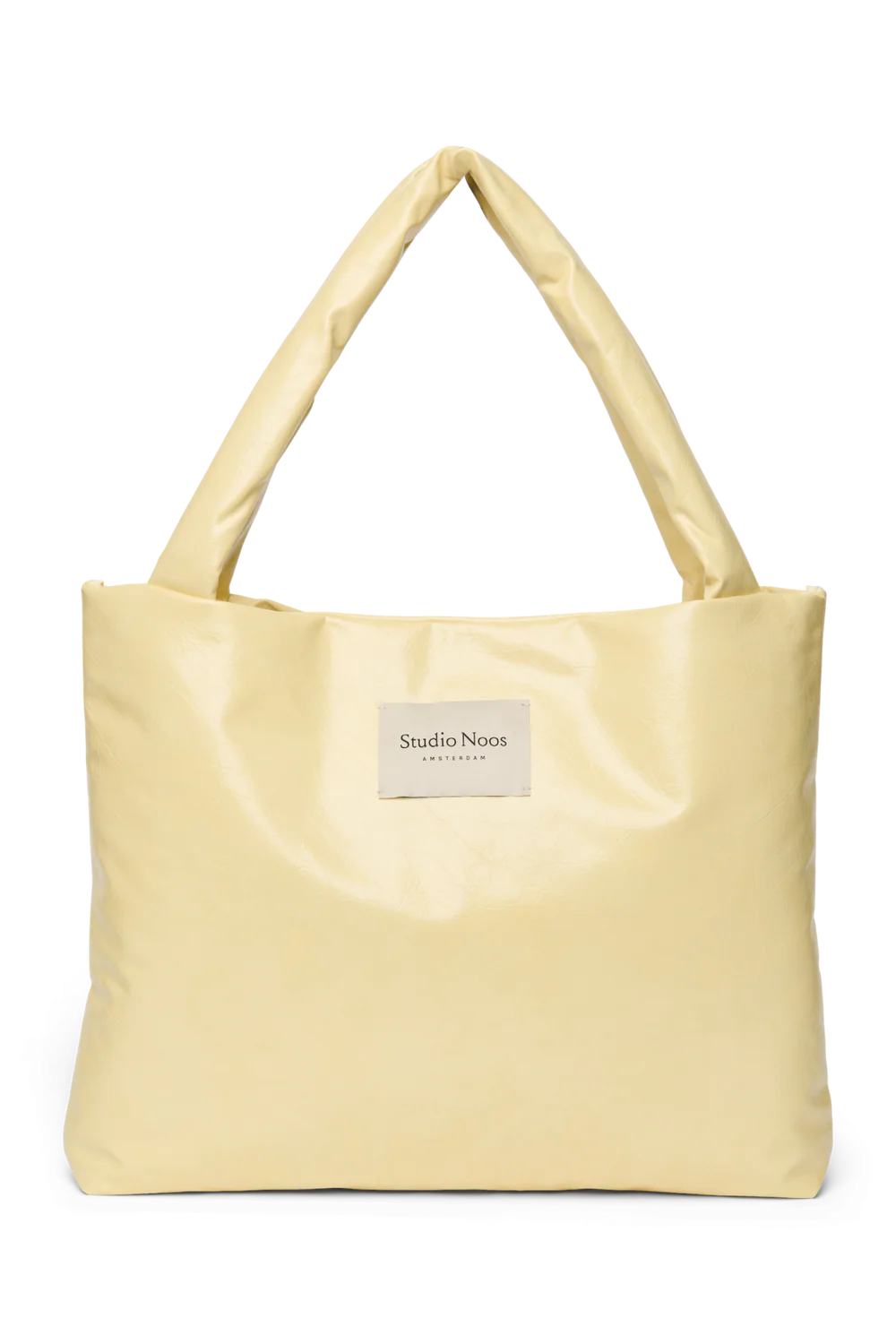 Vorderansicht: Studio Noos Vegan Leather Mom Bag in Buttergelb mit gepolsterten Griffen und kleinem Studio Noos Amsterdam Label vorne