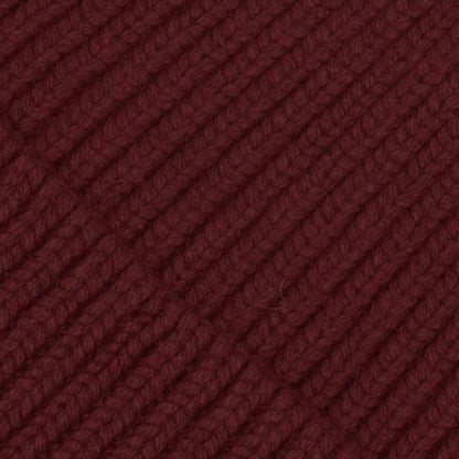 Detailansicht der Mütze LUMI X MATCHED von UNIO Hamburg in Dark Wine aus weichem Wolle-Kaschmir-Mix mit X vorne