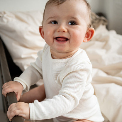 Baby-Seidenbody mit langen Ärmeln in der Farbe Cream aus beiger Seide, schlichtes und weiches Design für empfindliche Babyhaut